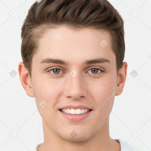 Joyful white young-adult male with short  brown hair and grey eyes