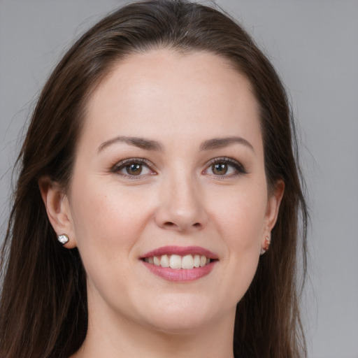 Joyful white young-adult female with long  brown hair and brown eyes