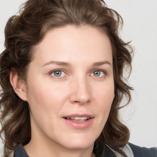 Joyful white young-adult female with medium  brown hair and blue eyes