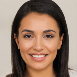 Joyful latino young-adult female with long  brown hair and brown eyes