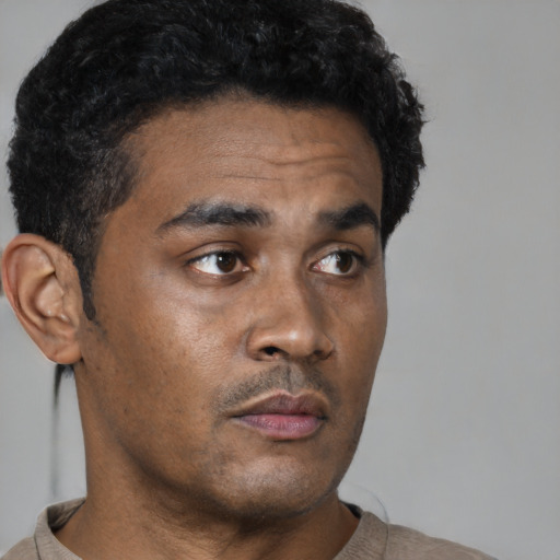 Neutral black young-adult male with short  black hair and brown eyes