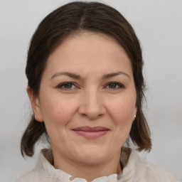 Joyful white adult female with medium  brown hair and brown eyes