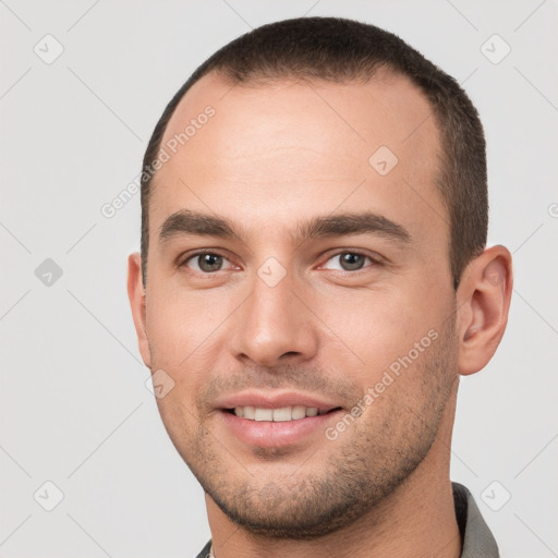 Joyful white young-adult male with short  brown hair and brown eyes