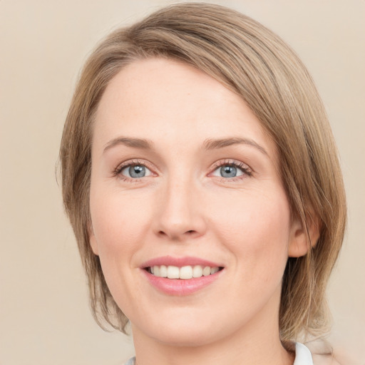 Joyful white young-adult female with medium  brown hair and green eyes