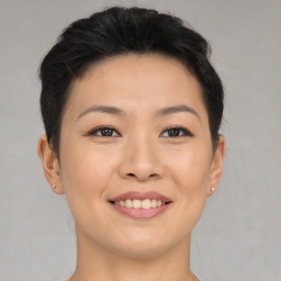 Joyful asian young-adult female with short  brown hair and brown eyes