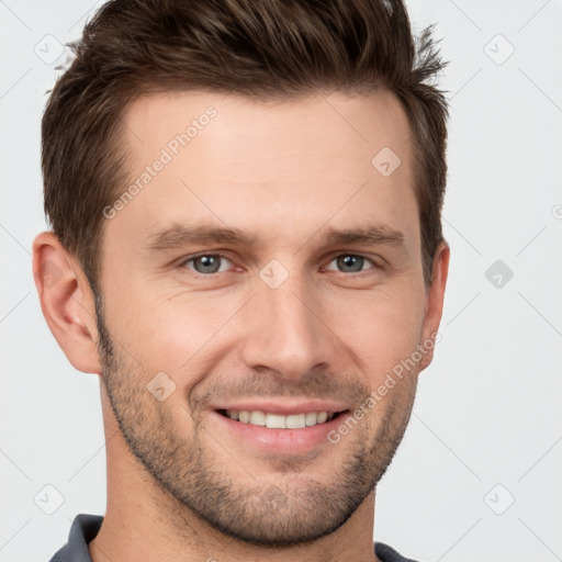 Joyful white young-adult male with short  brown hair and grey eyes