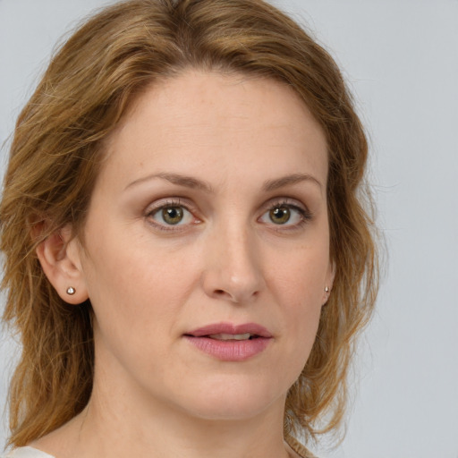 Joyful white young-adult female with long  brown hair and green eyes