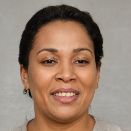Joyful latino adult female with short  brown hair and brown eyes
