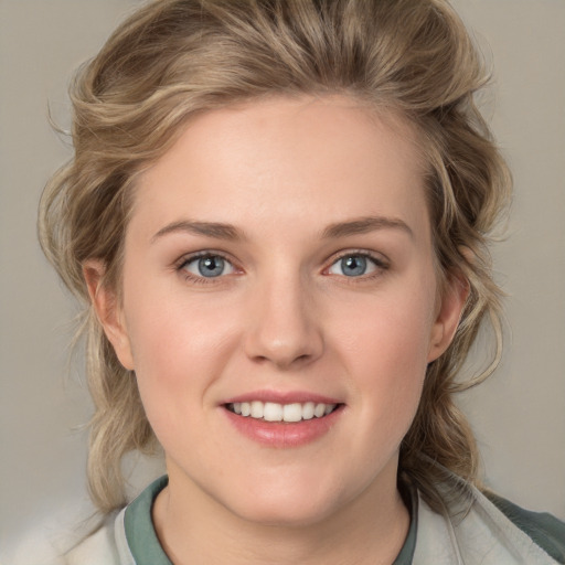 Joyful white young-adult female with medium  brown hair and blue eyes