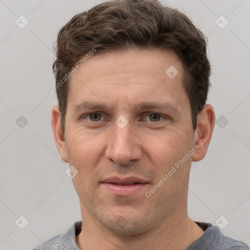 Joyful white adult male with short  brown hair and grey eyes