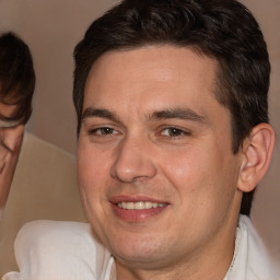 Joyful white adult male with short  brown hair and brown eyes