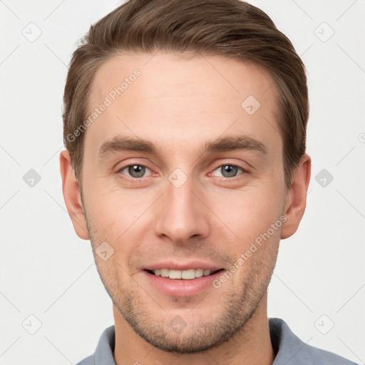 Joyful white young-adult male with short  brown hair and grey eyes