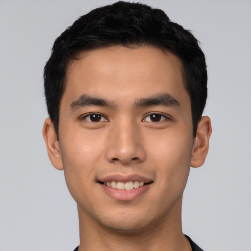 Joyful asian young-adult male with short  black hair and brown eyes