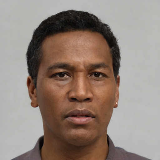Neutral black young-adult male with short  black hair and brown eyes