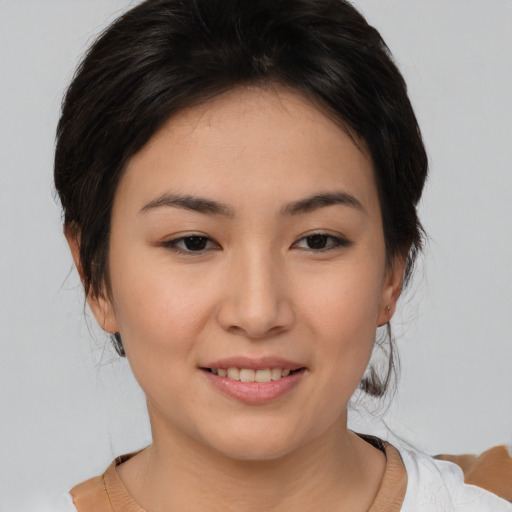 Joyful asian young-adult female with medium  brown hair and brown eyes