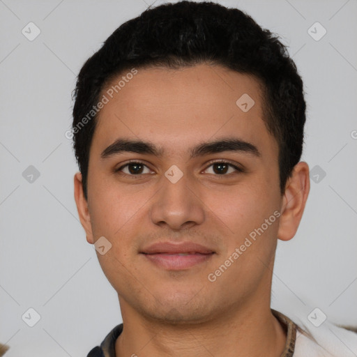 Joyful latino young-adult male with short  brown hair and brown eyes