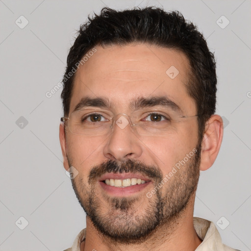 Joyful white adult male with short  brown hair and brown eyes