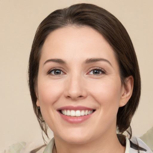 Joyful white young-adult female with medium  brown hair and brown eyes