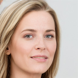 Joyful white young-adult female with long  brown hair and blue eyes