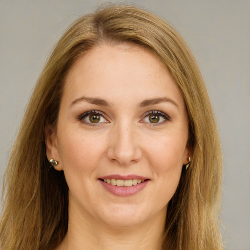 Joyful white young-adult female with long  brown hair and green eyes