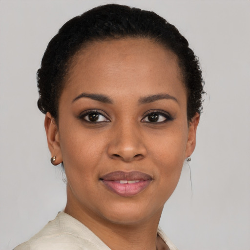 Joyful black young-adult female with short  brown hair and brown eyes