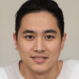 Joyful asian young-adult male with short  brown hair and brown eyes