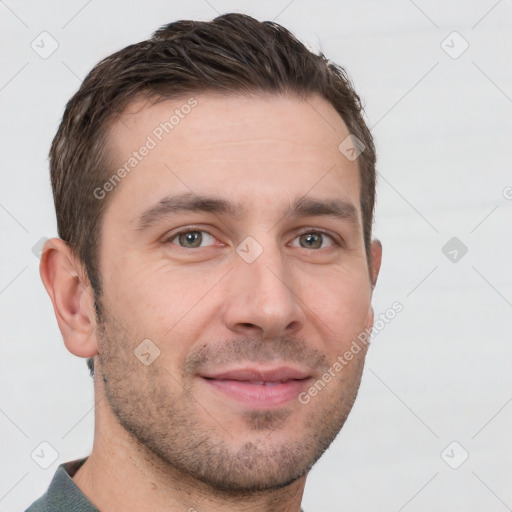 Joyful white young-adult male with short  brown hair and grey eyes