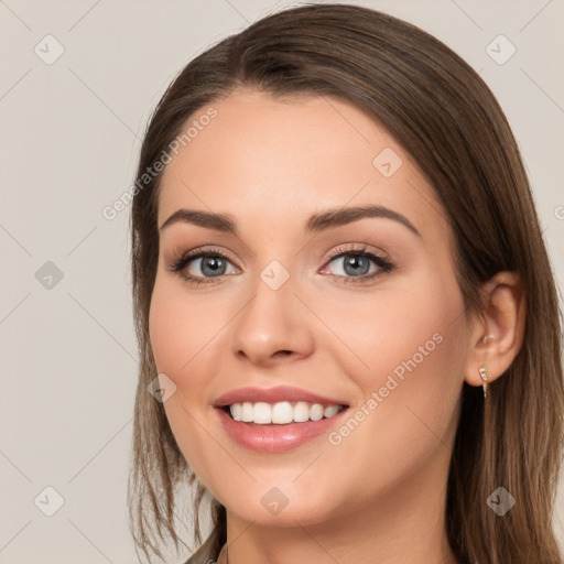 Joyful white young-adult female with long  brown hair and grey eyes