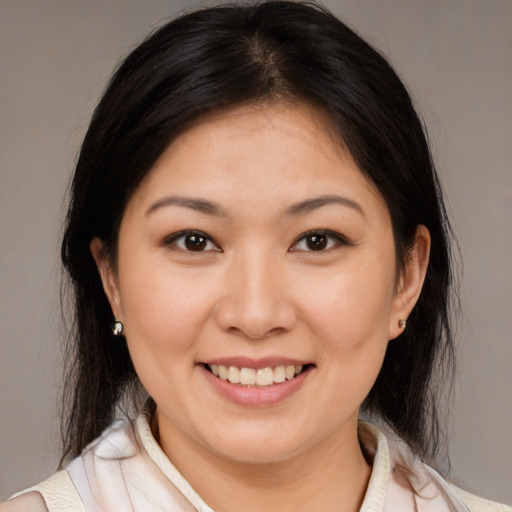 Joyful white young-adult female with medium  brown hair and brown eyes