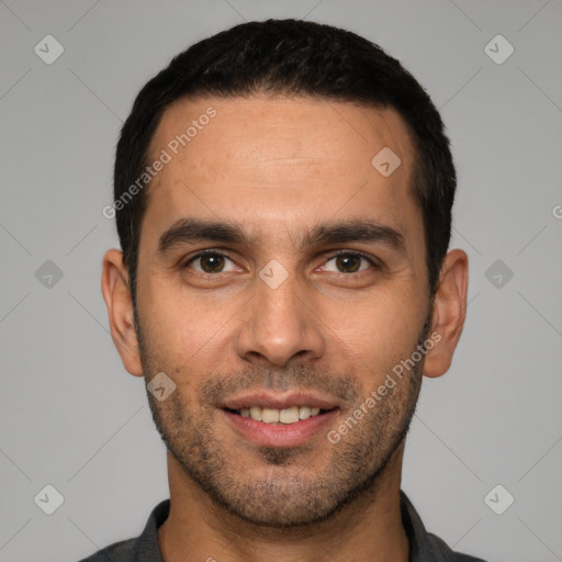 Joyful white young-adult male with short  black hair and brown eyes