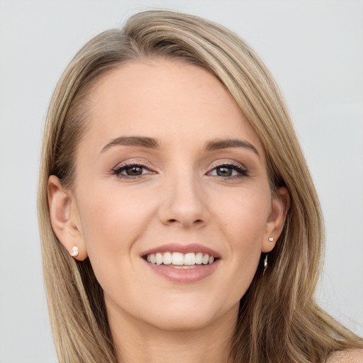 Joyful white young-adult female with long  brown hair and blue eyes