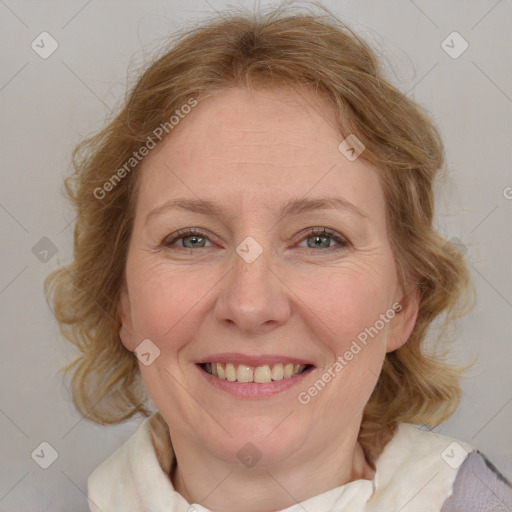 Joyful white adult female with medium  brown hair and blue eyes