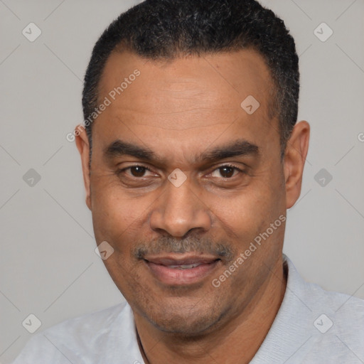 Joyful latino adult male with short  black hair and brown eyes