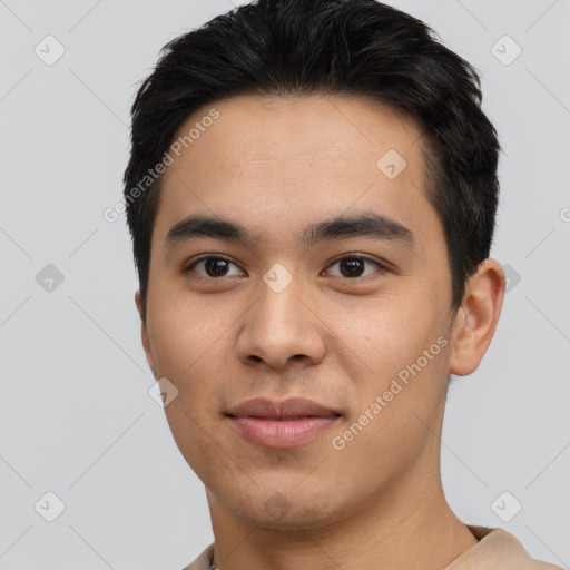 Joyful asian young-adult male with short  black hair and brown eyes