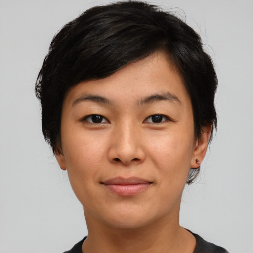 Joyful asian young-adult female with short  black hair and brown eyes