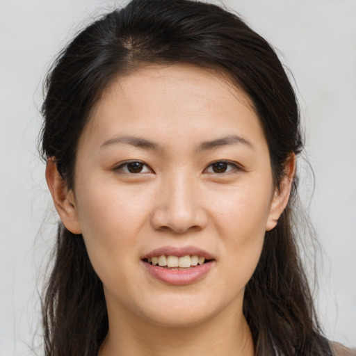 Joyful white young-adult female with long  brown hair and brown eyes