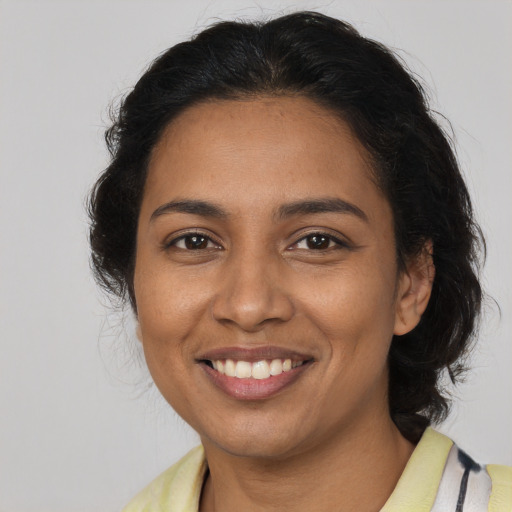 Joyful latino adult female with medium  brown hair and brown eyes