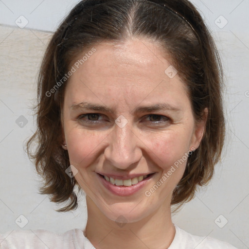 Joyful white adult female with medium  brown hair and blue eyes