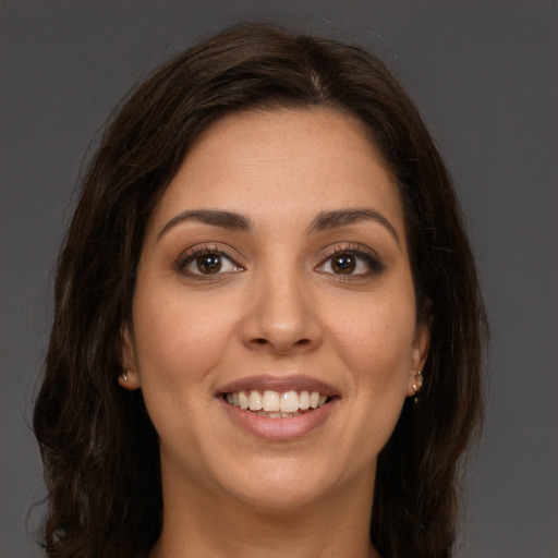 Joyful white young-adult female with long  brown hair and brown eyes