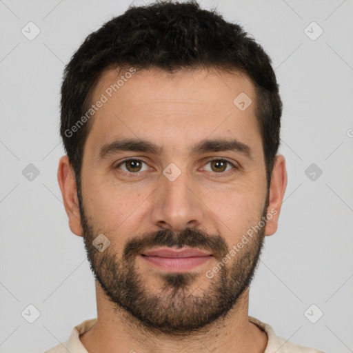 Joyful white young-adult male with short  black hair and brown eyes