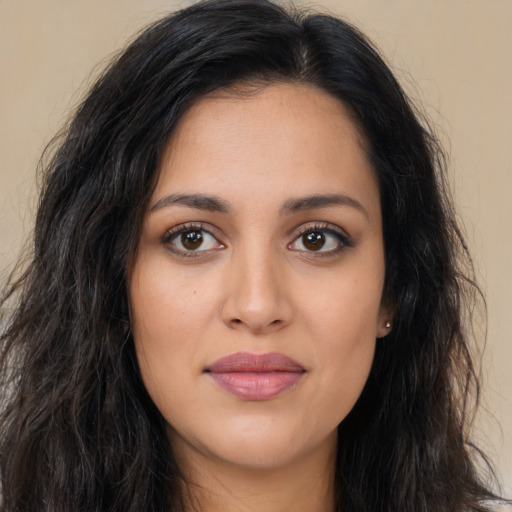 Joyful latino young-adult female with long  brown hair and brown eyes