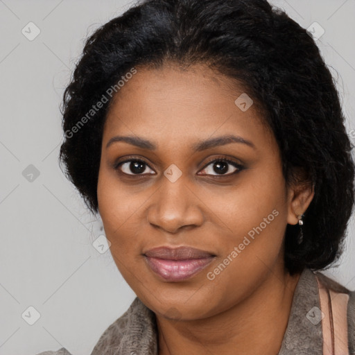 Joyful black young-adult female with long  black hair and brown eyes