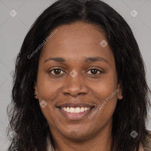 Joyful black adult female with long  brown hair and brown eyes