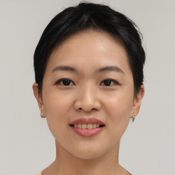 Joyful asian young-adult female with short  black hair and brown eyes