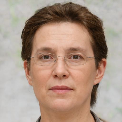 Joyful white adult female with medium  brown hair and blue eyes