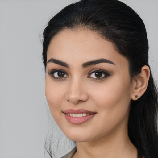 Joyful latino young-adult female with long  brown hair and brown eyes