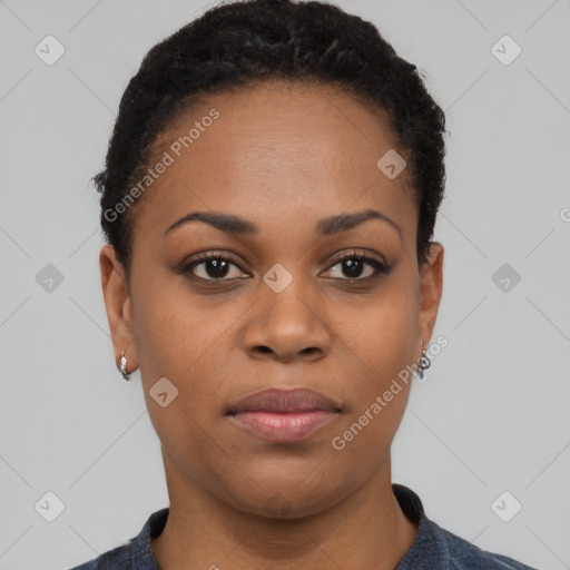 Joyful black young-adult female with short  black hair and brown eyes