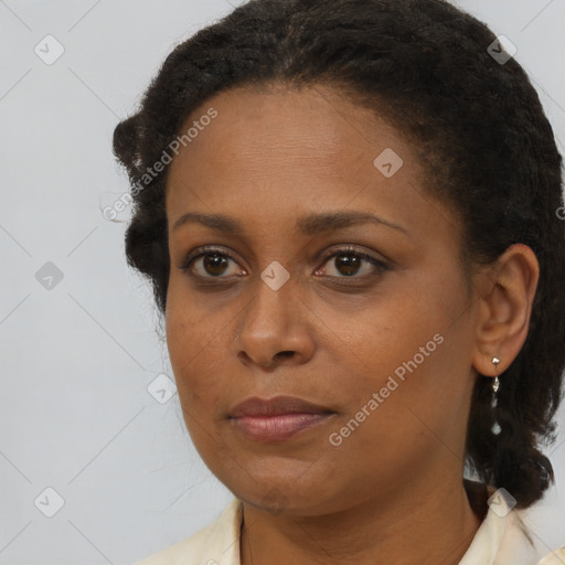Joyful black young-adult female with medium  brown hair and brown eyes