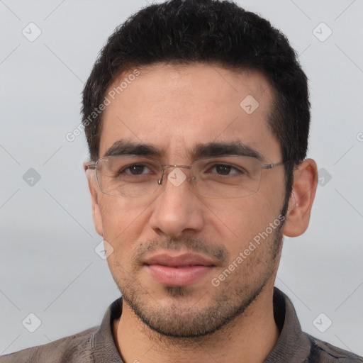 Joyful white young-adult male with short  black hair and brown eyes