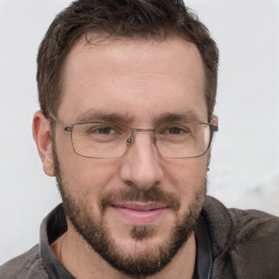 Joyful white adult male with short  brown hair and grey eyes